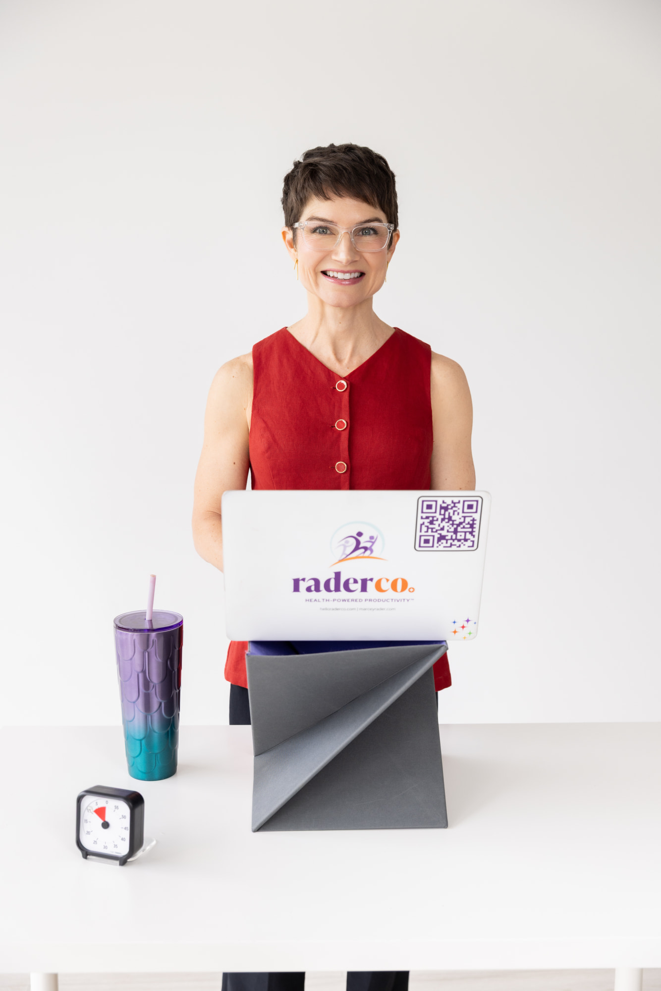 Marcey-Rader-Working-At-Portable-Standing-Desk (1) MR-smiling-at-computer-